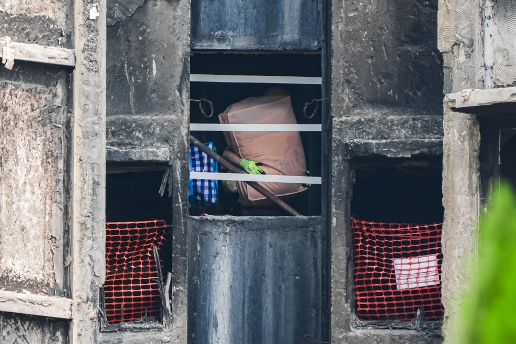 A resident collects personal belongings from Wang Sun House. Photo: Eugene Lee