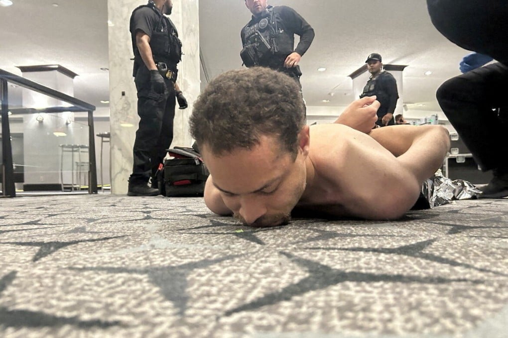 Law enforcement personnel detain Cole Tomas Allen, a suspect in the shooting incident at the White House Correspondents’ Association dinner, in Washington on Saturday. Photo: Donald J Trump via Truth Social/Reuters