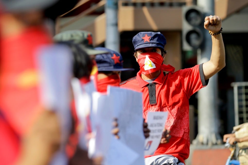 Masked protesters during a rally to commemorate the 49th anniversary of the New People’s Army, the armed wing of the Communist Party of the Philippines, near the Malacanang presidential palace in Manila, Philippines, in 2018. Photo: AP