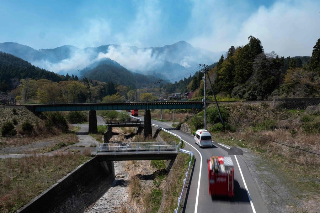 A convoy of fire trucks make their way to the fire in the town of Otsuchi in Iwate Prefecture, northern Honshu, Japan on Sunday. Photo: AFP