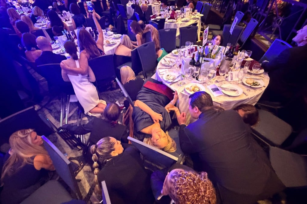 Guests take cover after US President Donald Trump and first lady Melania Trump were rushed out of the White House Correspondents’ Association dinner by Secret Service agents in Washington on Saturday. Photo: Reuters