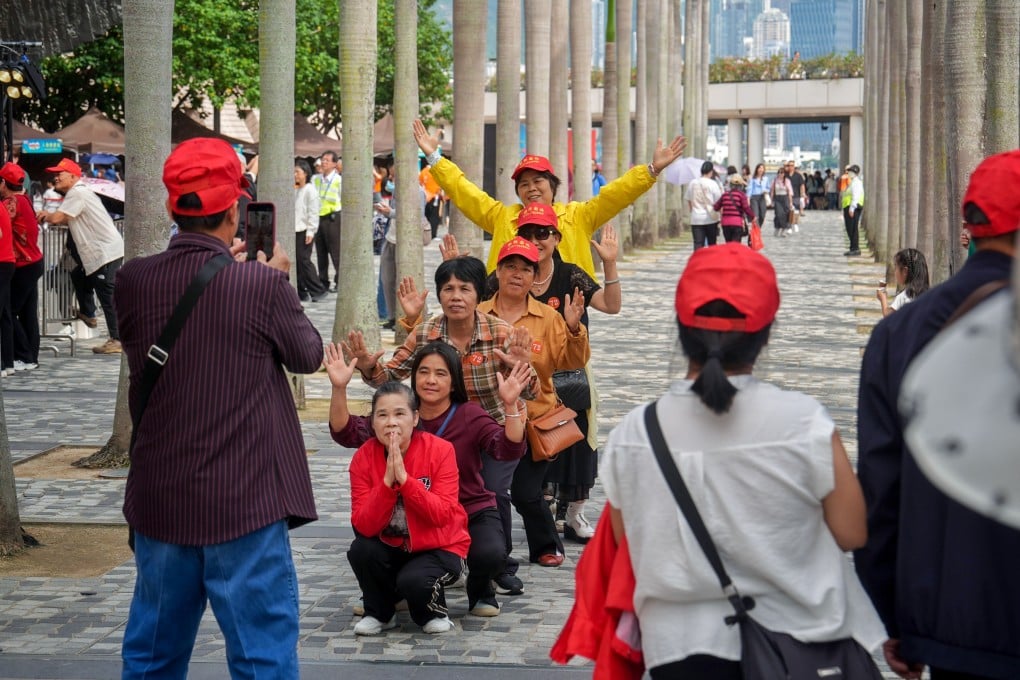 Mainland Chinese tourists pose for pictures outside the Hong Kong Cultural Centre in Tsim Sha Tsui on Saturday. Photo: Elson Li