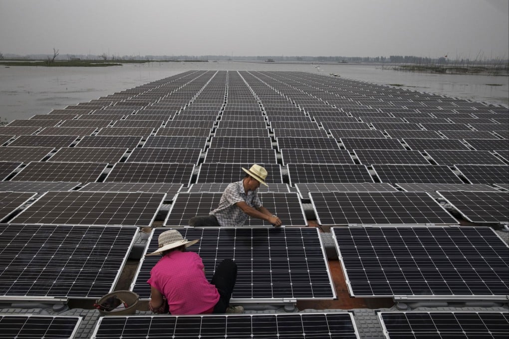 Workers prepare panels that will be part of a large floating solar farm project under construction by Sungrow Power Supply in Anhui province, China. Photo: Getty Images
