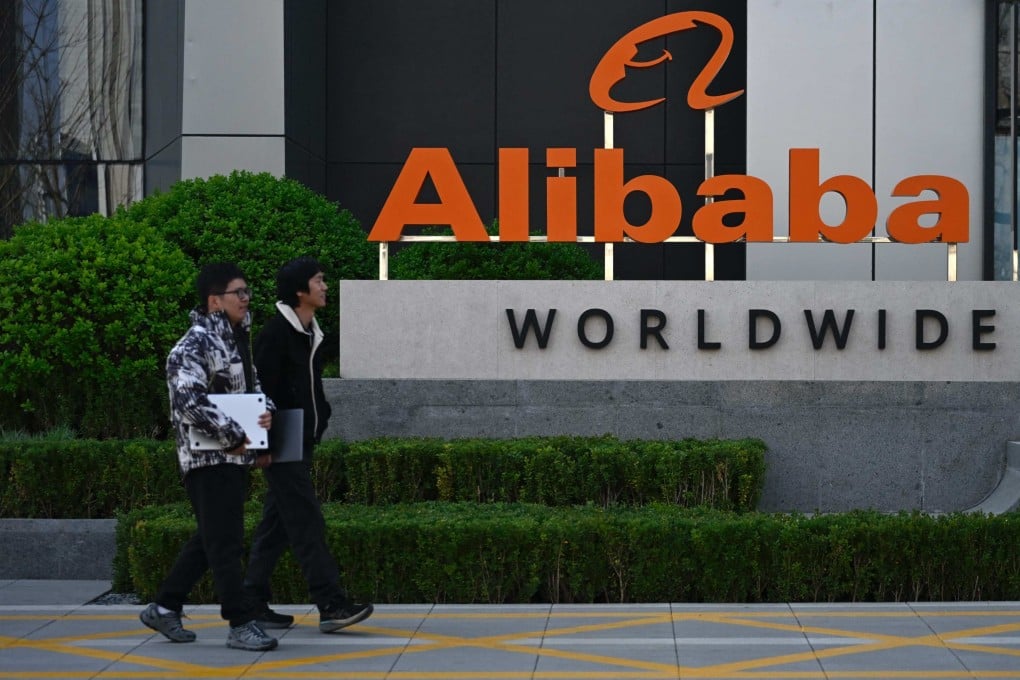 Employees walk past a company logo at the Alibaba office in Beijing on April 1, 2026. Photo: AFP