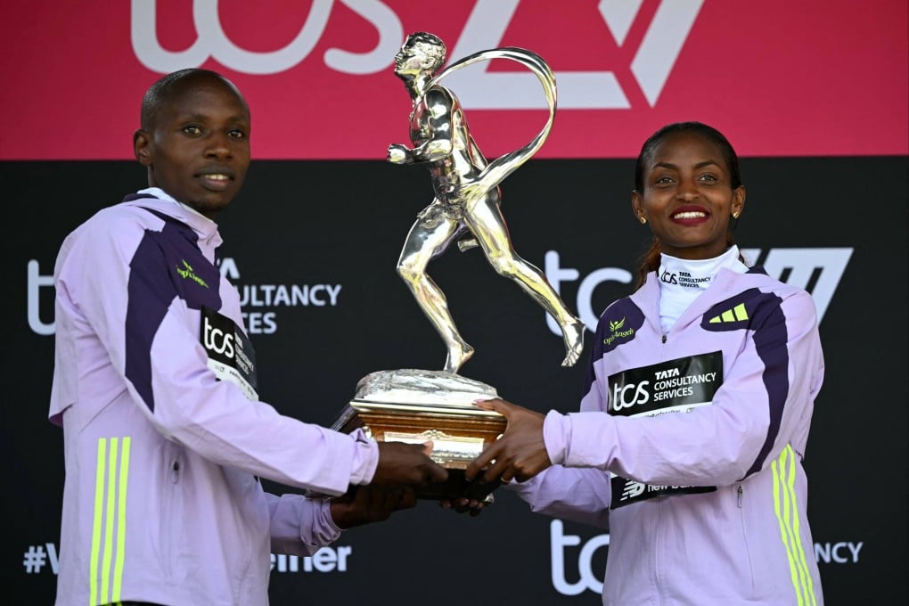 Marathon winners Sabastian Sawe (left) and Tigst Assefa with the Chris Brasher Sporting Life Trophy in London. Photo: AFP