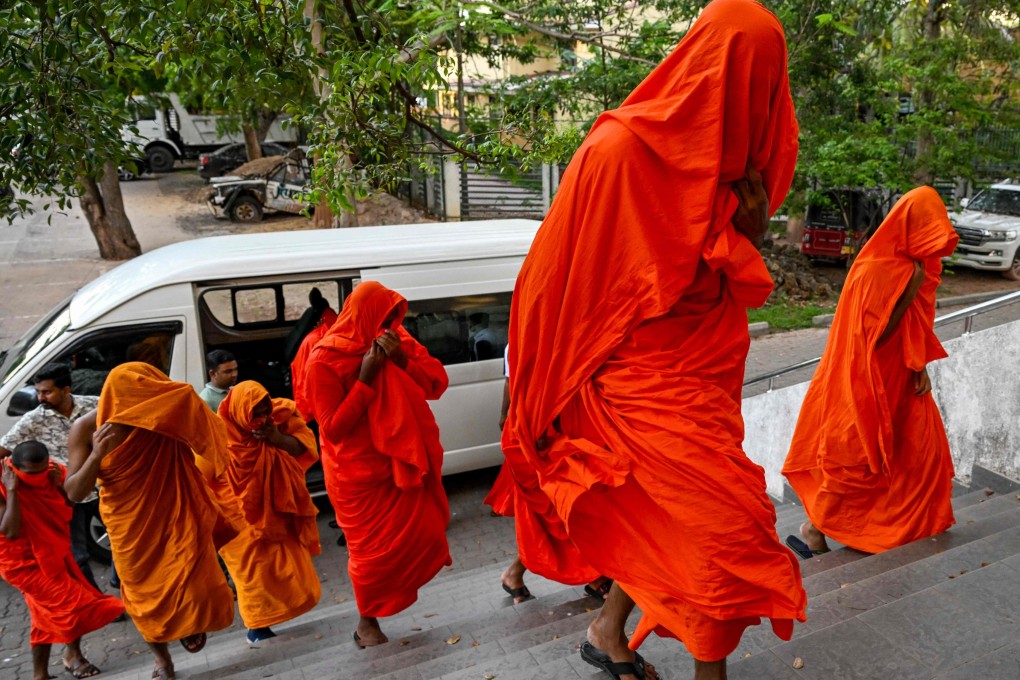 Sri Lankan monks arrive at court after their arrest in Negombo on Sunday. Photo: AFP
