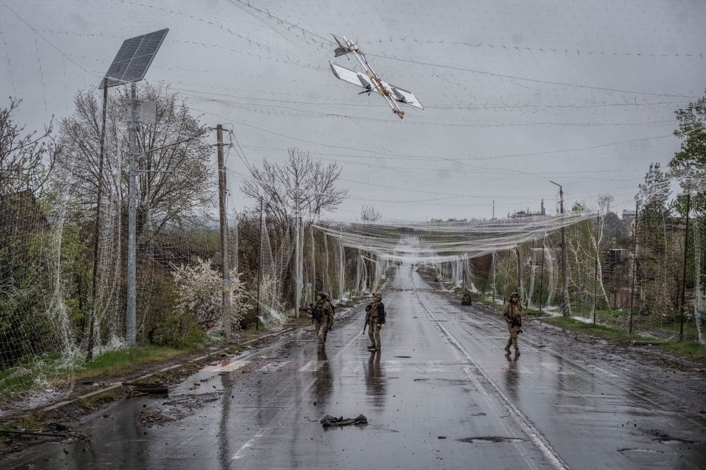 Ukrainian servicemen walk along a street under an anti-drone net in the frontline town of Druzhkivka, Donetsk region, Ukraine. Photo; Reuters