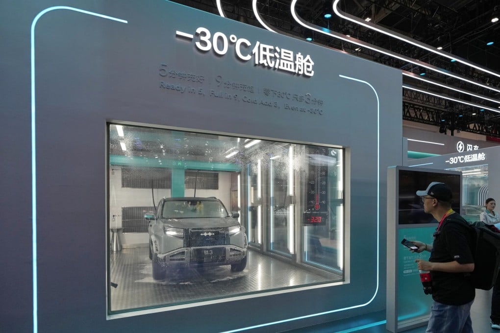 Visitors look at a chamber with sub-zero temperatures that showcases battery-charging technology at the Beijing Auto Show. Photo: AP