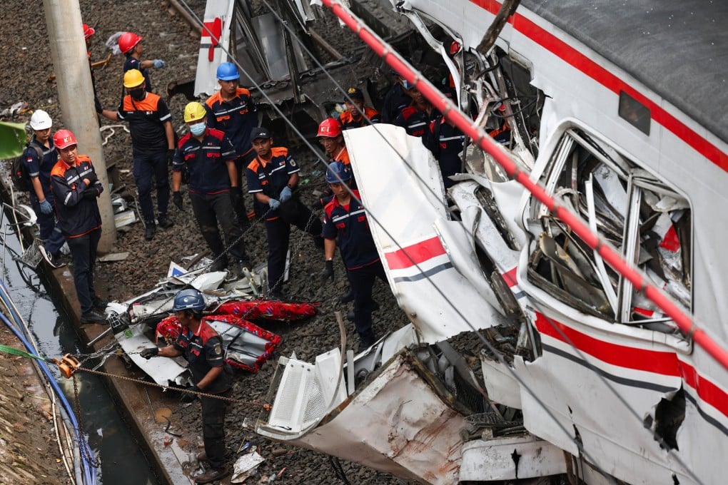 Technicians work on site after a deadly collision between a commuter line train and a long-distance train in Bekasi, on the outskirts of Jakarta, Indonesia, on Tuesday. Photo: Reuters