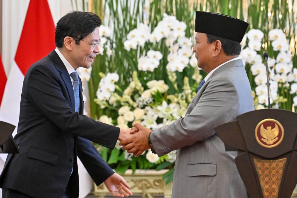 Indonesia’s President Prabowo Subianto (right) shakes hands with Singapore’s Prime Minister Lawrence Wong after a press conference at the presidential palace in Jakarta in November 2024. Photo: AFP