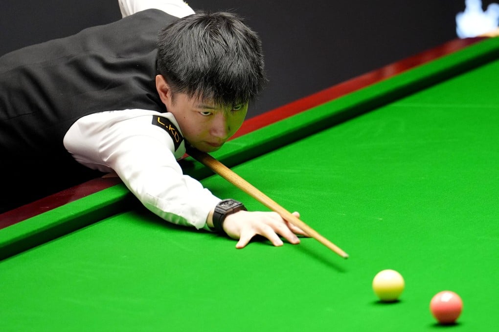 Zhao Xintong plays a shot against Shaun Murphy on day eleven of the World Snooker Championship in Sheffield, England on Tuesday. Photo: AP
