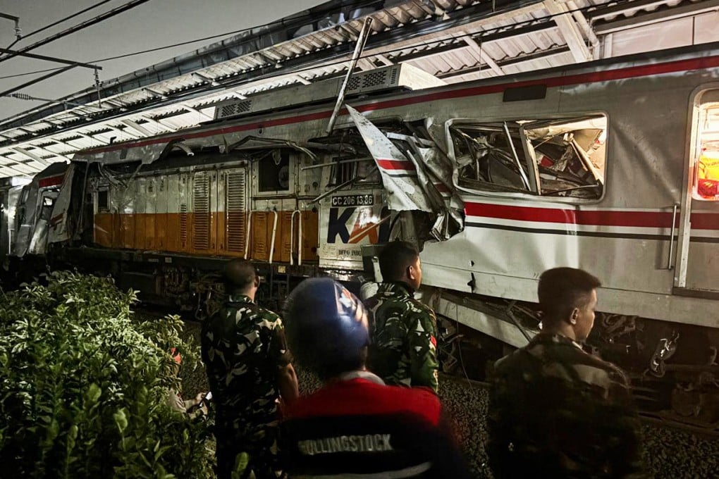 Indonesian soldiers examine the damage after a train crash at a station in Bekasi, Indonesia, on Tuesday. Photo: AP