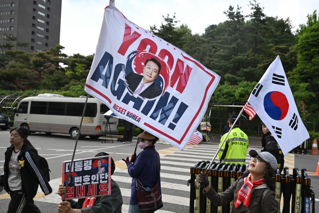Supporters of South Korea’s former president Yoon Suk-yeol wave flags near the Seoul High Court in Seoul on Tuesday. Photo: AFP