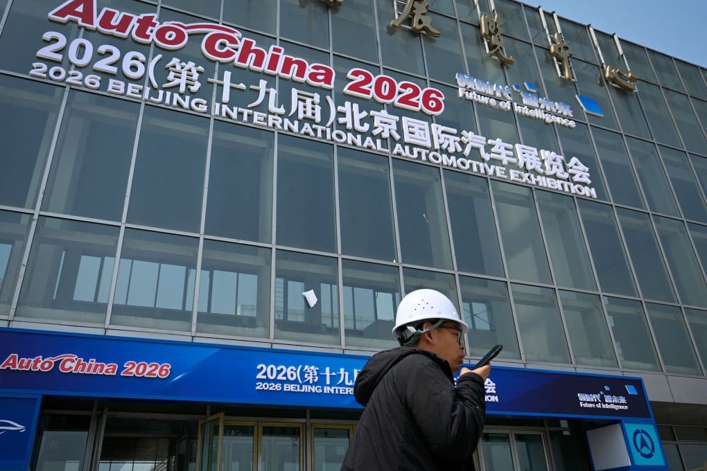 A worker walks past the venue of this year’s Beijing Auto Show at the China International Exhibition Center in Beijing on April 23. Photo: AFP