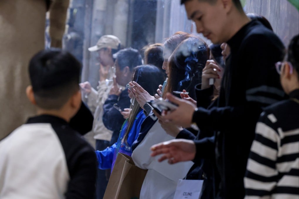 People smoke traditional and e-cigarettes in Causeway Bay in January 2025. Smoking is one of the risk factors for nasopharyngeal cancer. Photo: Nora Tam