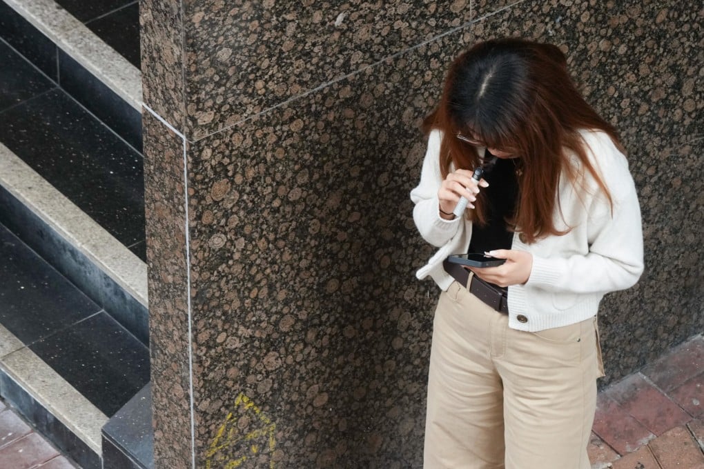 A woman is spotted smoking near the footbridge connecting Harcourt Garden and the Central Government Offices in Tamar. Photo: Jelly Tse