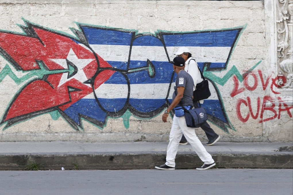 People walk past a mural with the Cuban flag in Havana, Cuba, on April 15. Photo: EPA