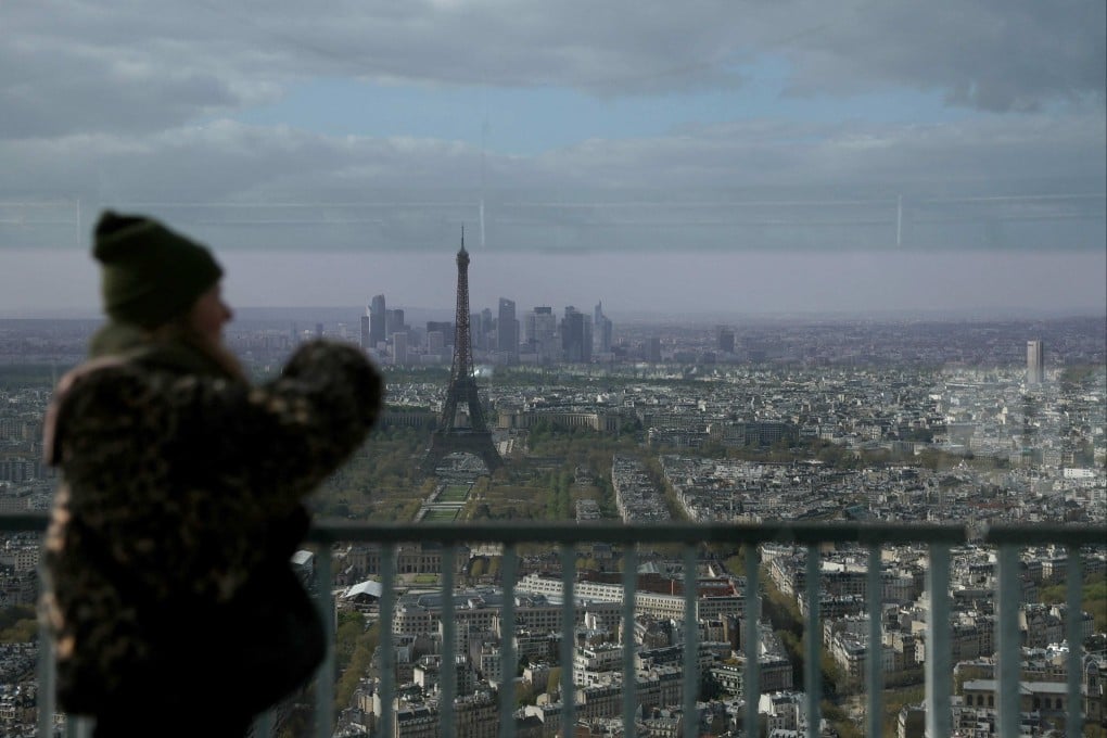 A woman looks out towards the Eiffel Tower. The cyberattack has raised questions in France over the safety for citizens to have all their information stored in a centralised database. Photo: AFP