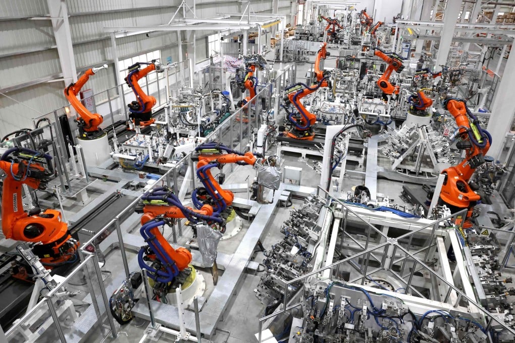 Robots work on production lines at a mould and stamping company in Fuzhou, in China’s eastern Fujian province, on April 16. Photo: AFP