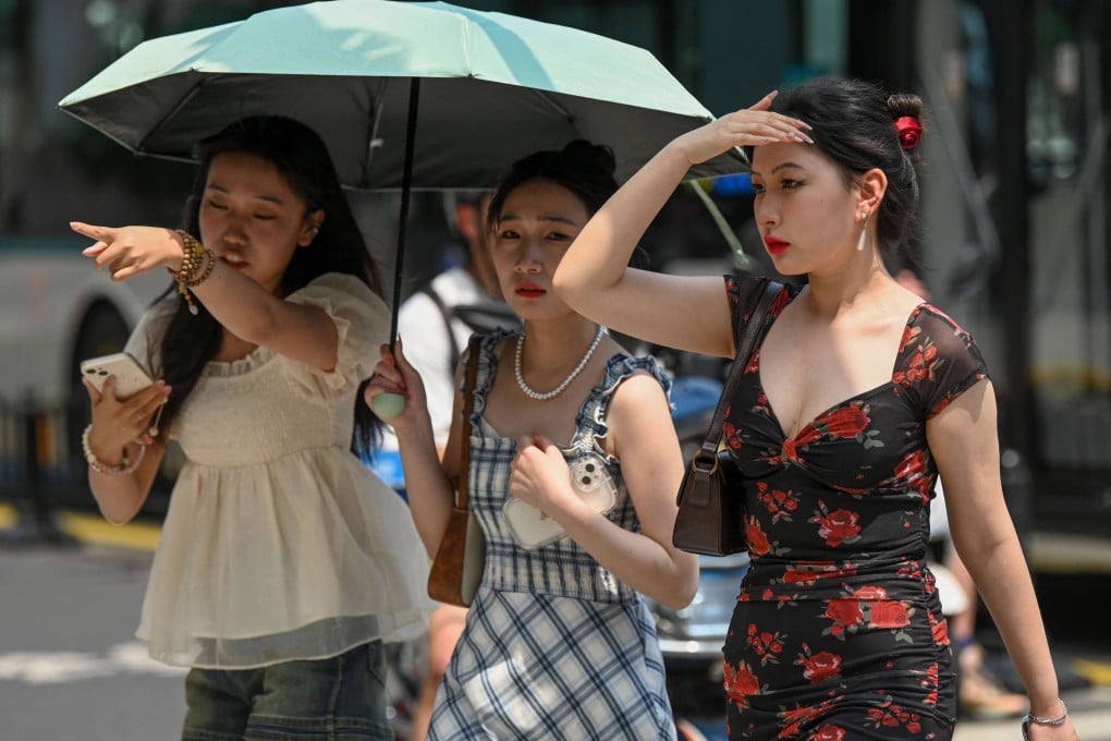 Women use an umbrella to shelter from the sun in Shanghai in May 2023, a month before an El Nino event began to send temperatures soaring even higher. Photo: AFP