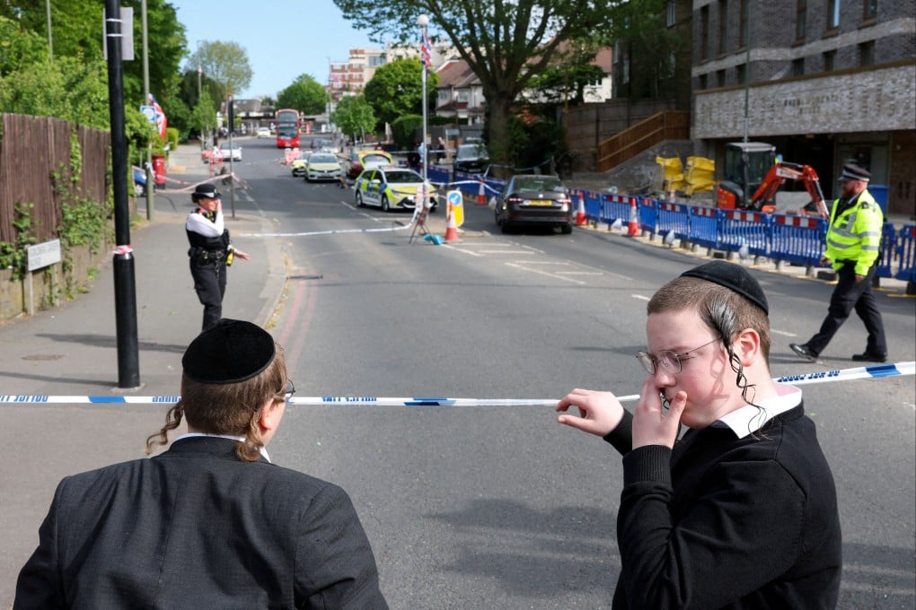 Orthodox Jews stand by a police cordon after a man was arrested following a stabbing incident in the Golders Green area on Wednesday. Photo: Reuters