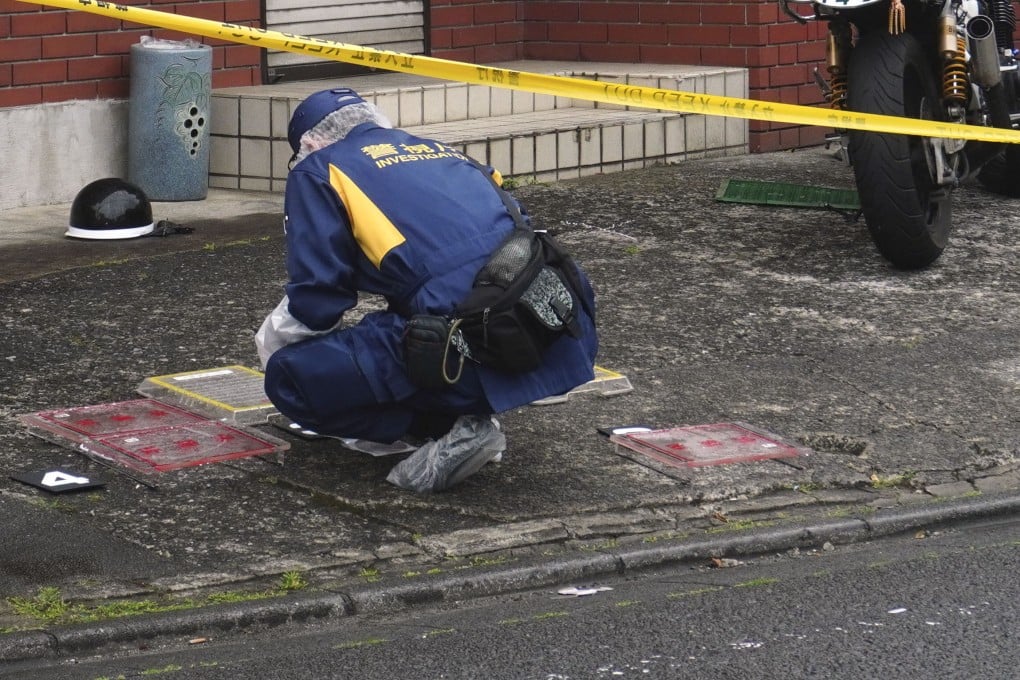 A police officer investigates the scene where a high school student was struck on the head with a hammer by a man in Fussa, western Tokyo, on Wednesday. Photo: Kyodo