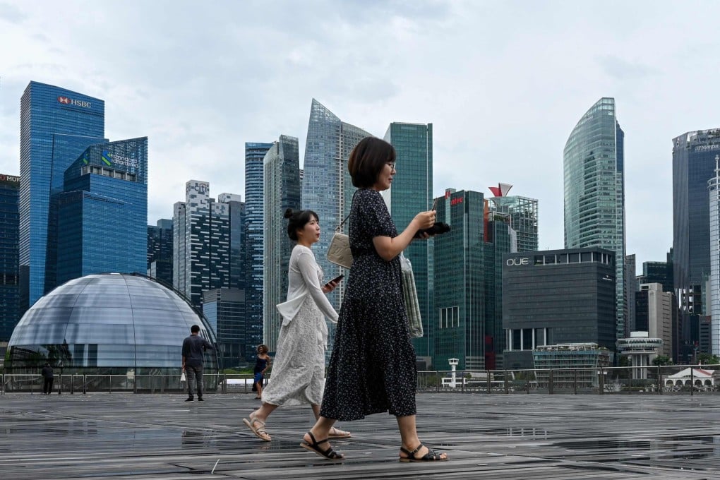 People walk on the boardwalk in front of Singapore’s financial centre. Photo: AFP