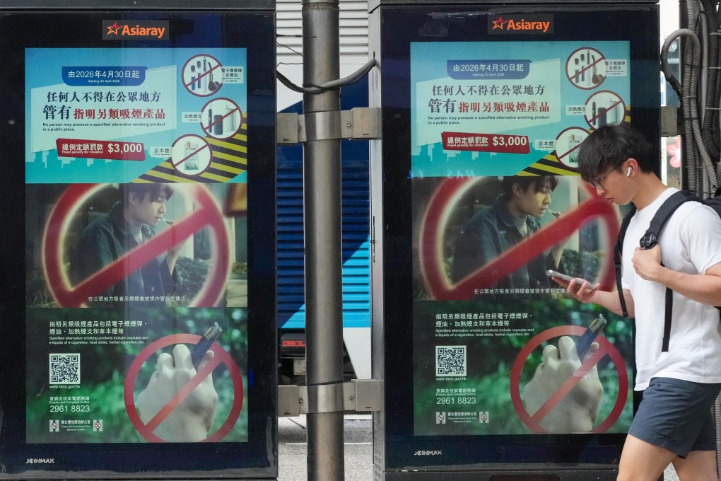 A pedestrian walks past at a bus stop in Tsim Sha Tsui with an advertisement promoting the ban on the public use of alternative smoking products, on April 28. Photo: Jelly Tse
