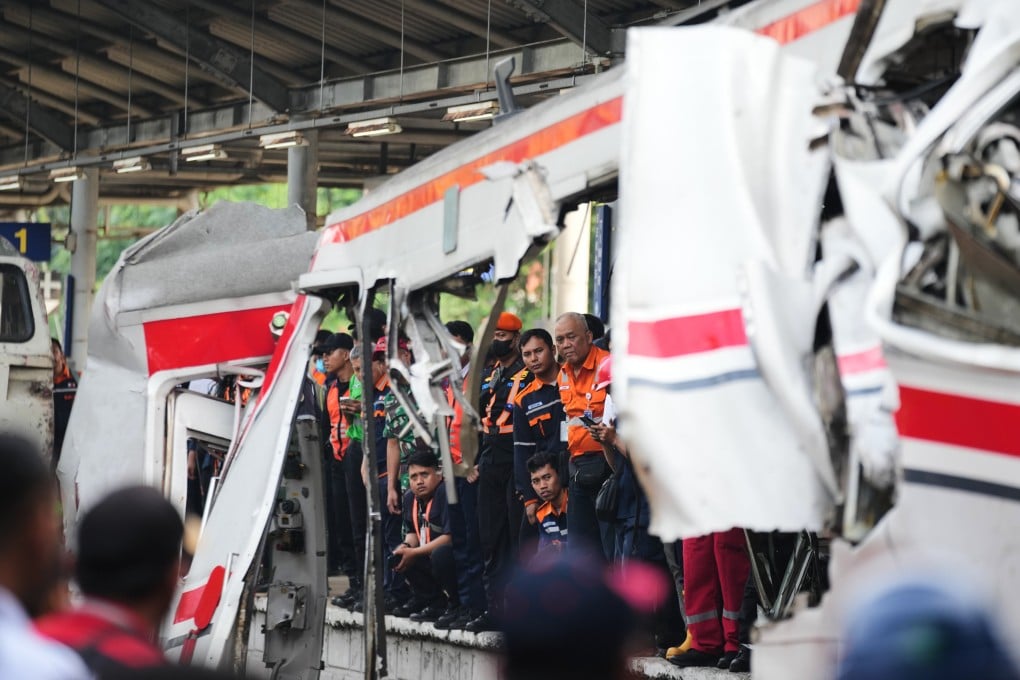 Workers and rescuers on Tuesday examine the wreckage following a train collision in Bekasi, Indonesia. Photo: AP