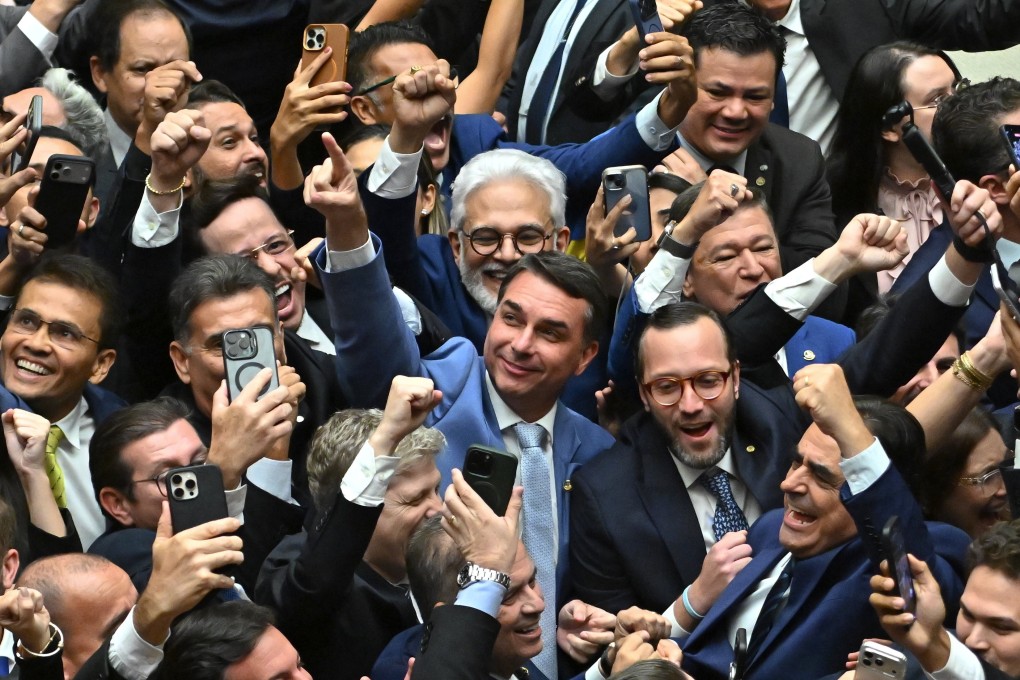 Senator Flavio Bolsonaro, son of former Brazilian president Jair Bolsonaro, celebrates with members of Congress on Thursday. Photo: EPA