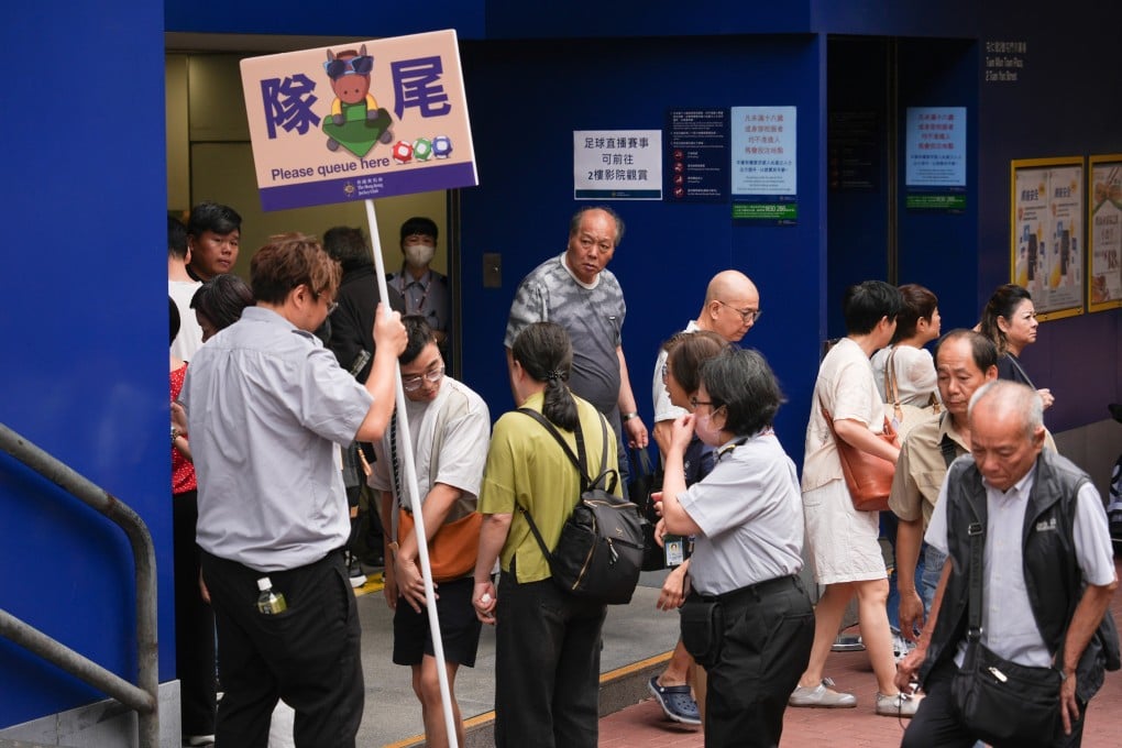Residents queue up to buy Mark Six tickets on Saturday. Photo: Eugene Lee