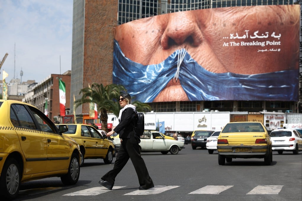 A woman walks past an anti-US billboard depicting US President Donald Trump and the Strait of Hormuz, in Tehran, Iran, on Saturday. Photo: Reuters