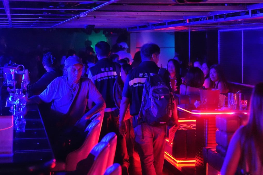 Tobacco and Alcohol Control Office officers conduct checks for illegal vaping at a bar in Lan Kwai Fong on Friday. Photo: Elson Li