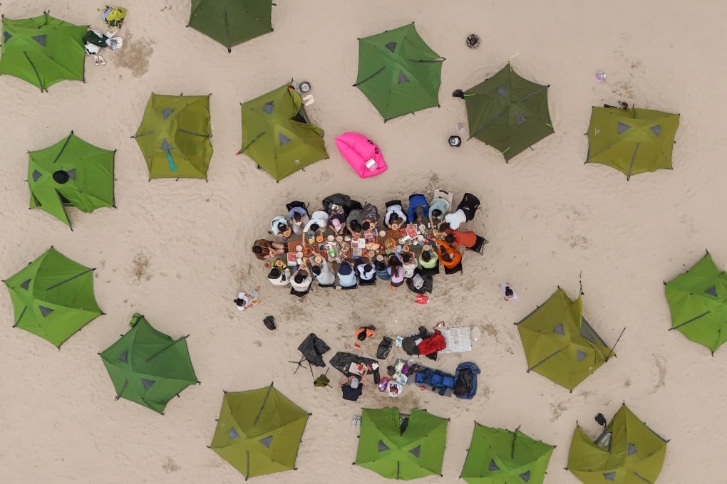 Members of an unlicensed tour group eat hotpot at the Ham Tin Wan campsite. Photo: Edmond So