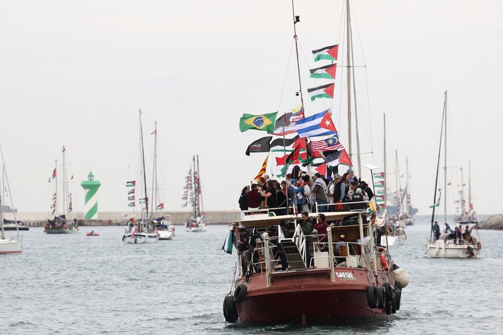 Boats of a new humanitarian flotilla bound for the Gaza Strip make a symbolic departure from Barcelona’s Port Vell on April 12, after the departure of the flotilla was postponed due to bad weather. Photo: AFP
