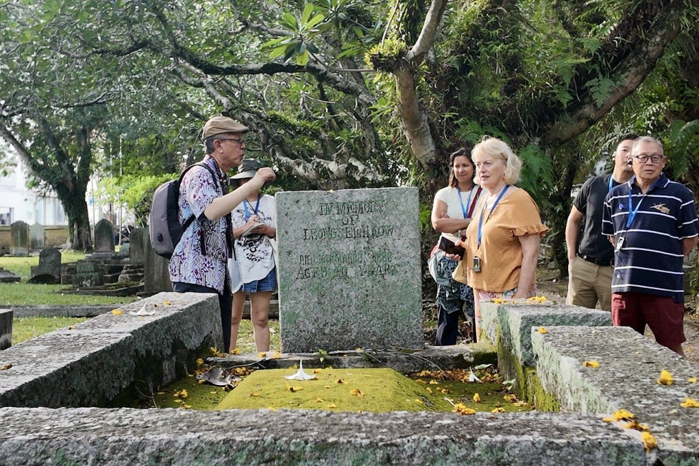 Tour guide Zul Harris (left) leads a tour of the Old Protestant Cemetery in Penang, Malaysia. Photo: Ushar Daniele