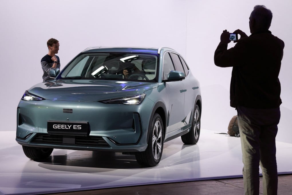 A journalist takes pictures of the Geely E5 electric compact SUV car presented at the launch of Geely Auto France in Paris on April 28. Photo: Reuters