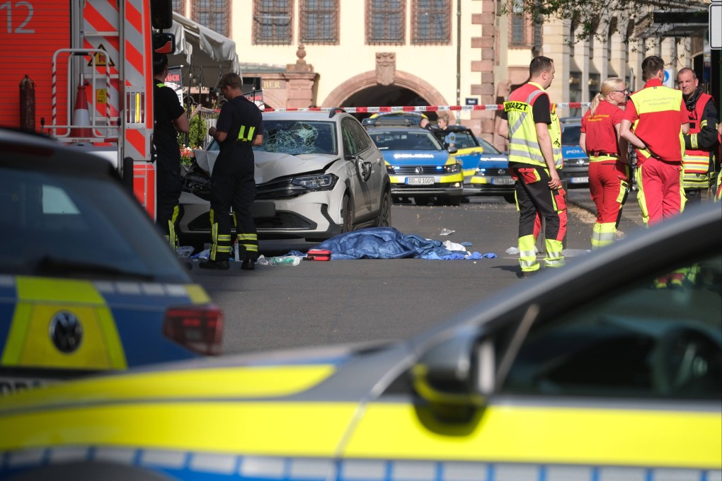 Rescuers next to a damaged vehicle at the scene of a fatal car ramming in Leipzig, Germany on Monday. Photo: dpa