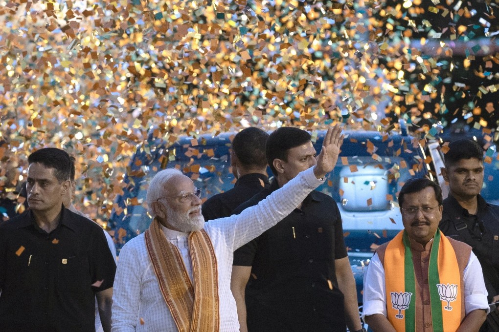 Bharatiya Janata Party leader and Indian Prime Minister Narendra Modi (waving) arrive at the party headquarters to deliver a victory speech, in New Delhi on Monday. Photo: EPA
