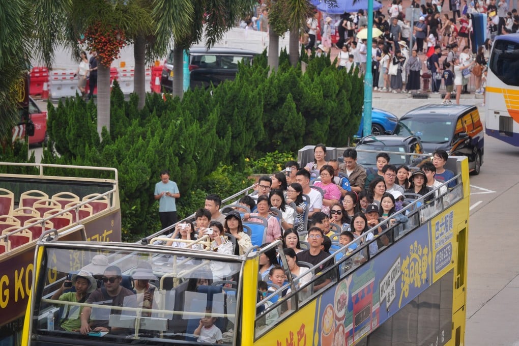 Tourists ride in an open-top bus in Central during the Labour Day holiday. Authorities expect about 980,000 mainland Chinese visitors to come to Hong Kong for the break. Photo: Elson Li
