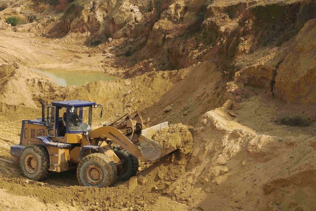 A skip loader shifts earth at a rare earth metals mine in China’s Jiangxi province. Photo: Reuters
