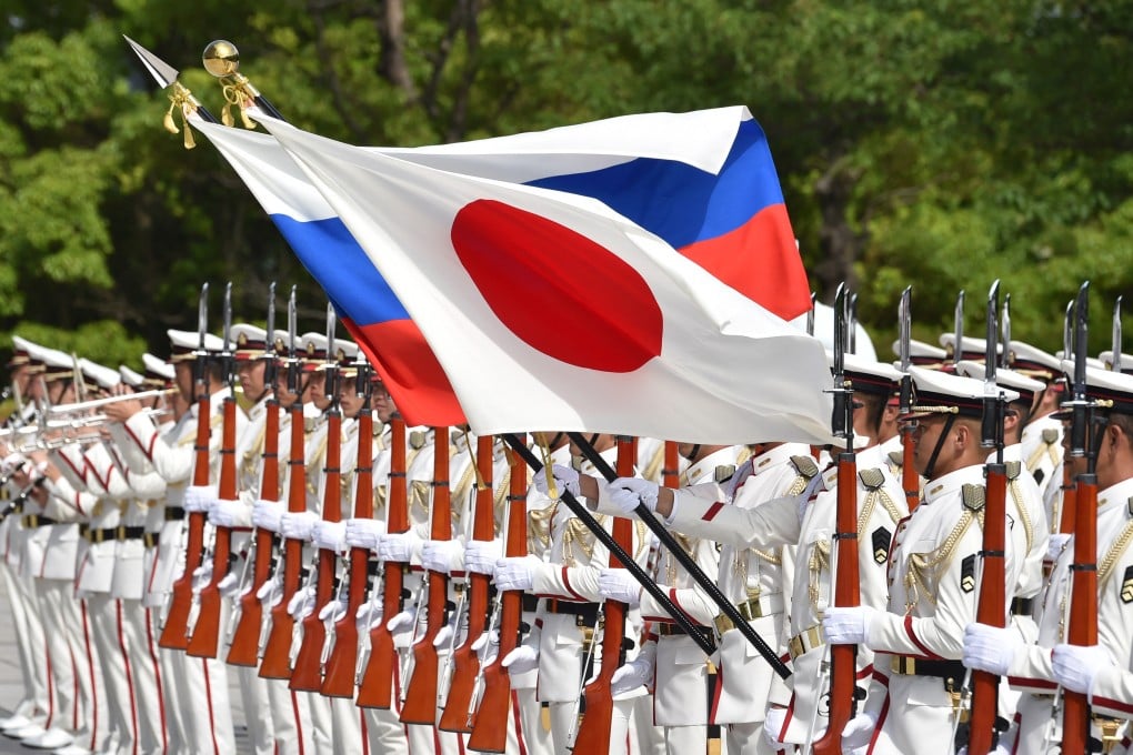 Honour guards hold the national flags of Japan and Russia before a welcome ceremony for then Russian defence minister Sergei Shoigu in Tokyo in 2019. Photo: AFP