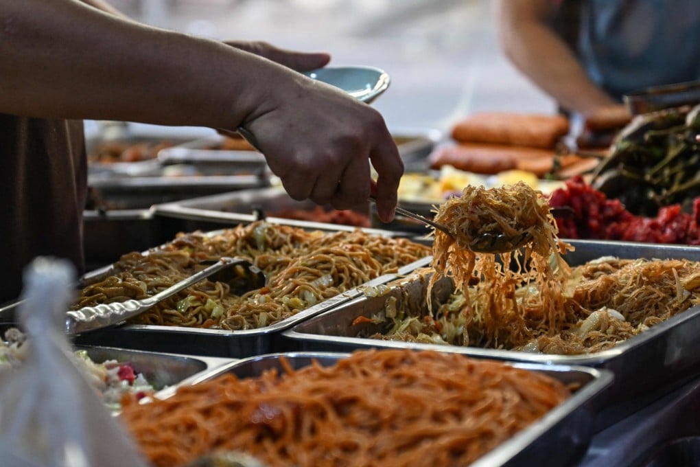A man scops up food at a canteen in Manila on April 7. Photo: AFP