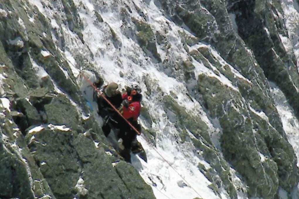 Firefighters from Nagano Prefecture’s disaster relief team rescue a stranded hiker (left). Photo: Handout