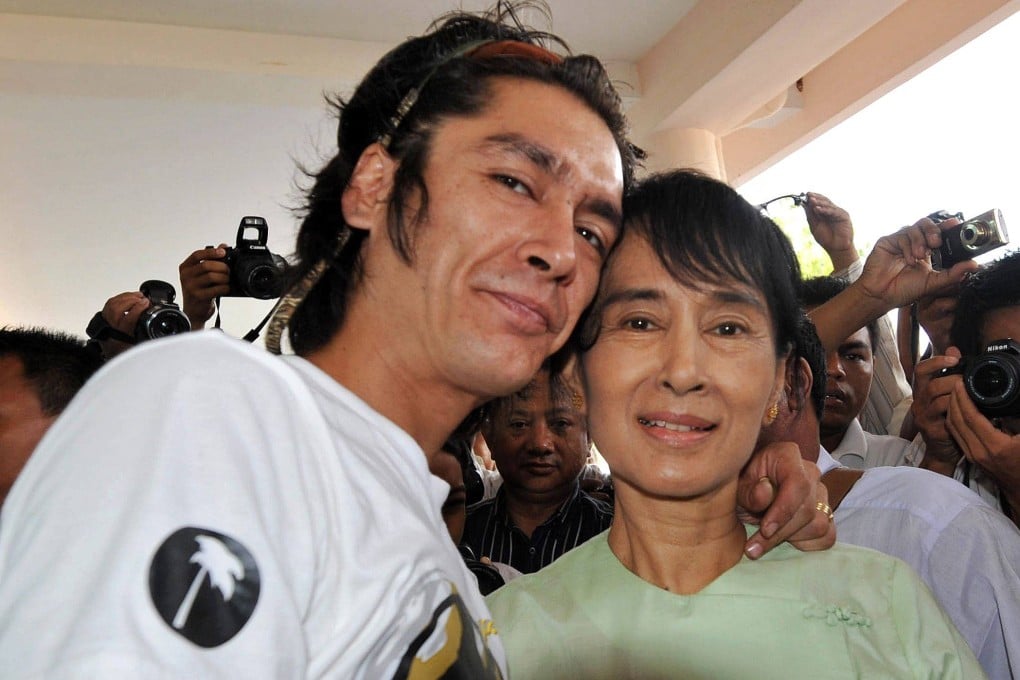 Aung San Suu Kyi and her son, Kim Aris, pose for pictures at the airport in the ancient temple city of Bagan before flying back to Yangon on July 8, 2011. Photo: AFP
