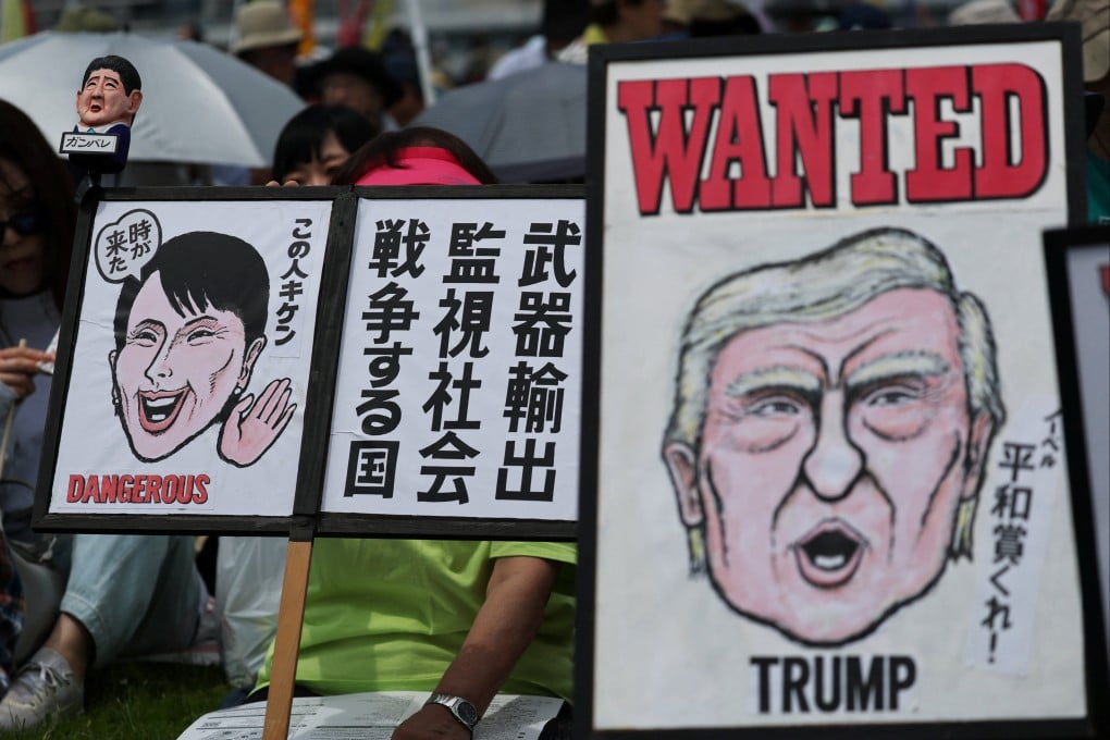 Protesters hold placards representing Japan’s Prime Minister Sanae Takaichi and US President Donald Trump  in Tokyo on Sunday. Photo: Reuters