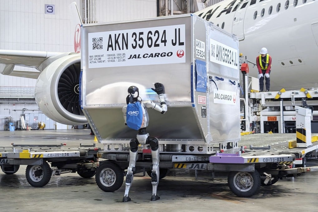 A humanoid robot pushes a cargo container during a media demonstration at Haneda airport in Tokyo. Photo: Reuters