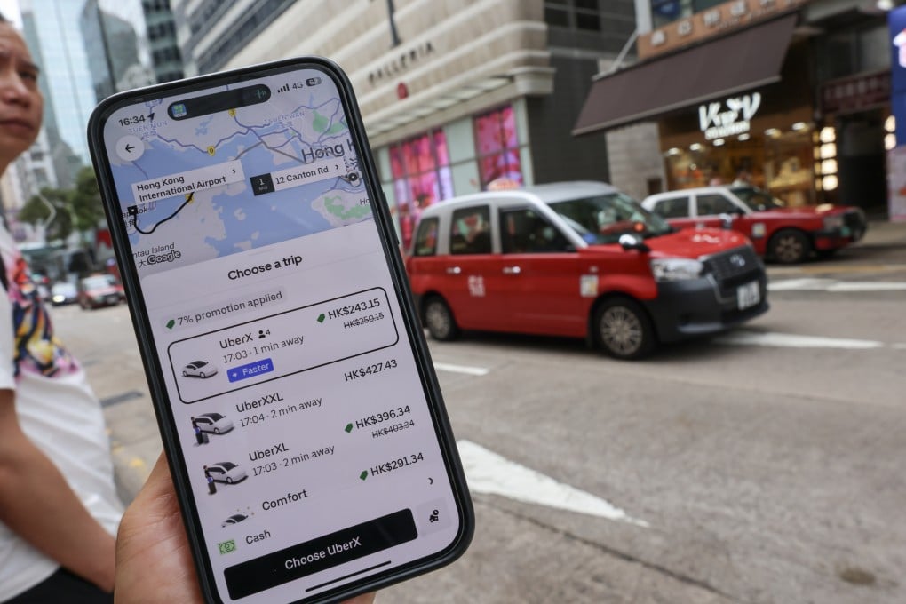 The Uber app is seen opened on a mobile phone as a taxi drives past in Tsim Sha Tsui on May 16, 2025. Photo: Jelly Tse