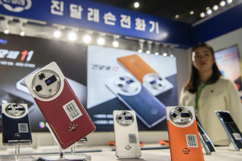 Domestically produced Jindallae mobile phones are displayed during the Pyongyang Spring International Trade Fair on Monday. Photo: AFP