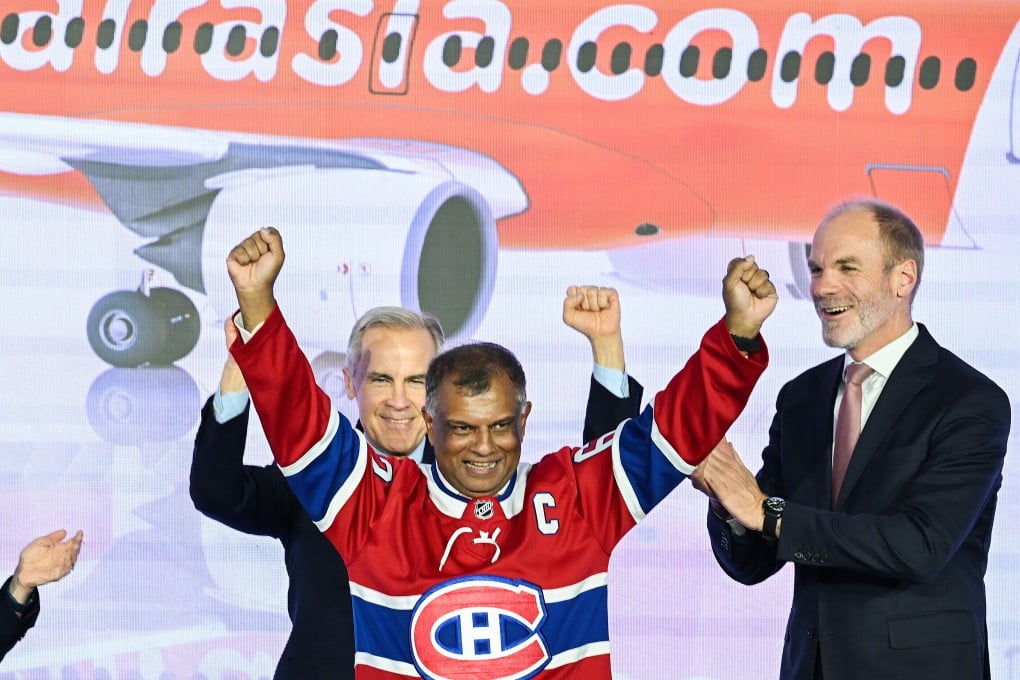 Canada’s Prime Minister Mark Carney (left) and Lars Wagner, CEO, Airbus Commercial Aircraft (right), cheer on AirAsia co-founder Tony Fernandes during an event in Quebec, Canada, on Wednesday. The Canadian Press via AP